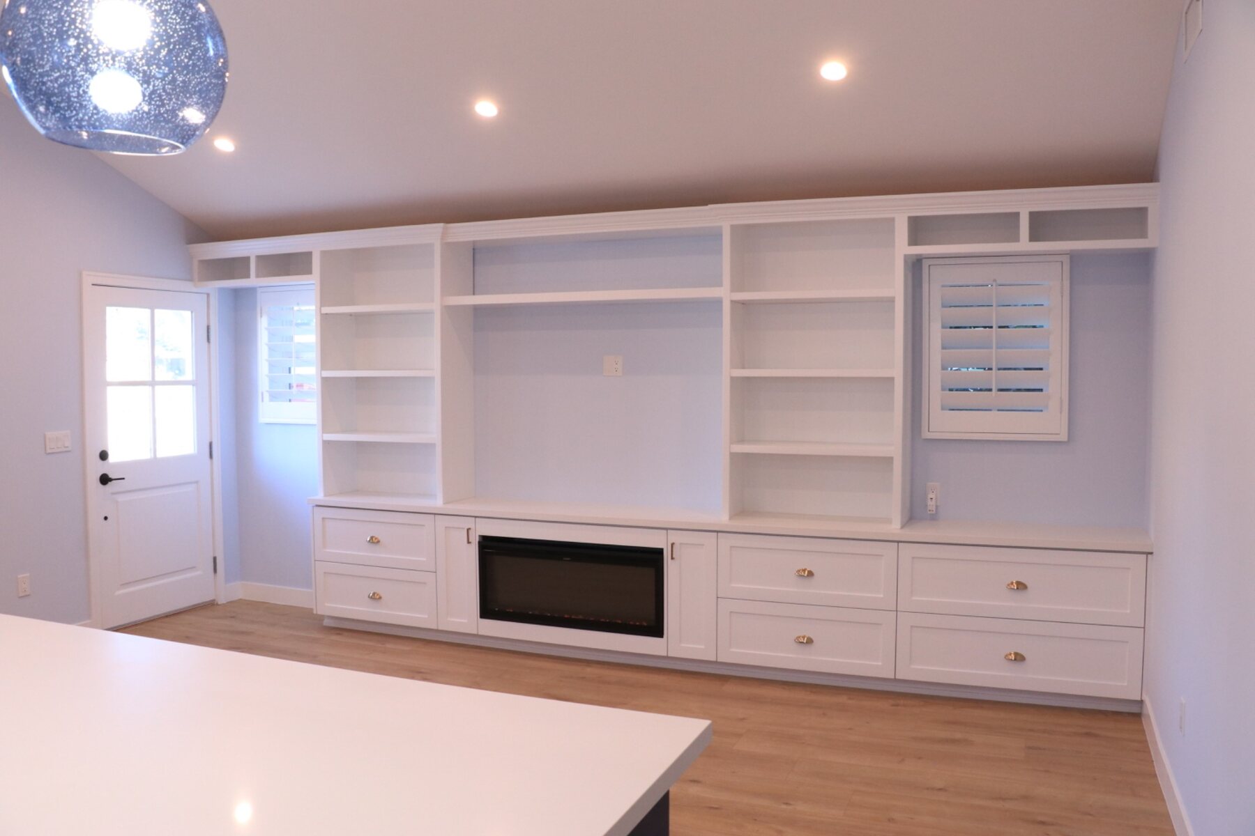 Custom built-in cabinetry surrounding a modern fireplace